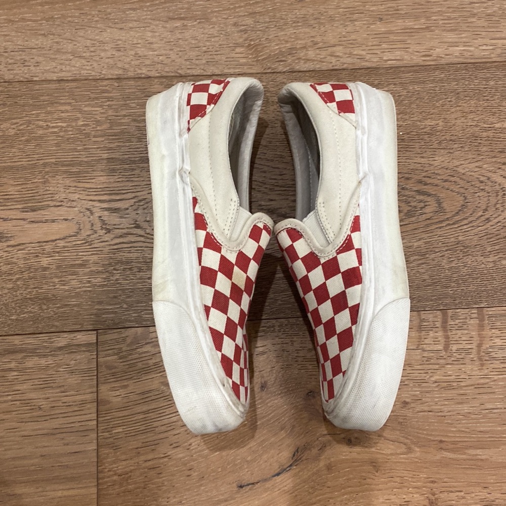 Red and white checkered slip on vans, size women’s 7 men’s 5.5.